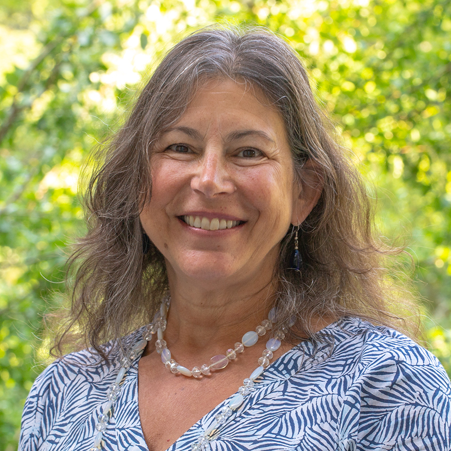 headshot of A. Tracy Hassett in front of a tree