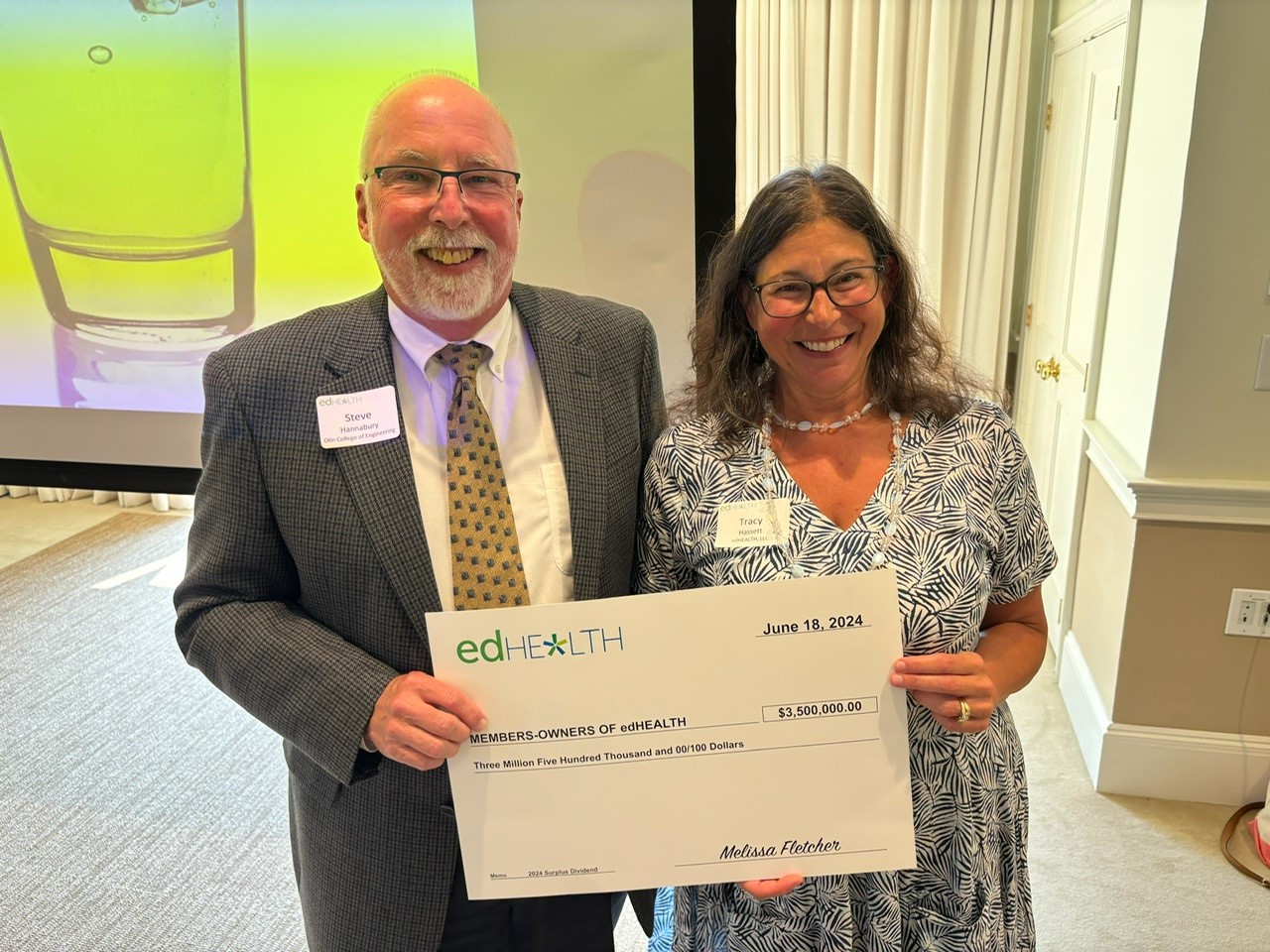 edHEALTH Chair of the Boards Stephen Hannabury with President and CEO Tracy Hassett holding a big check for $3.5 million