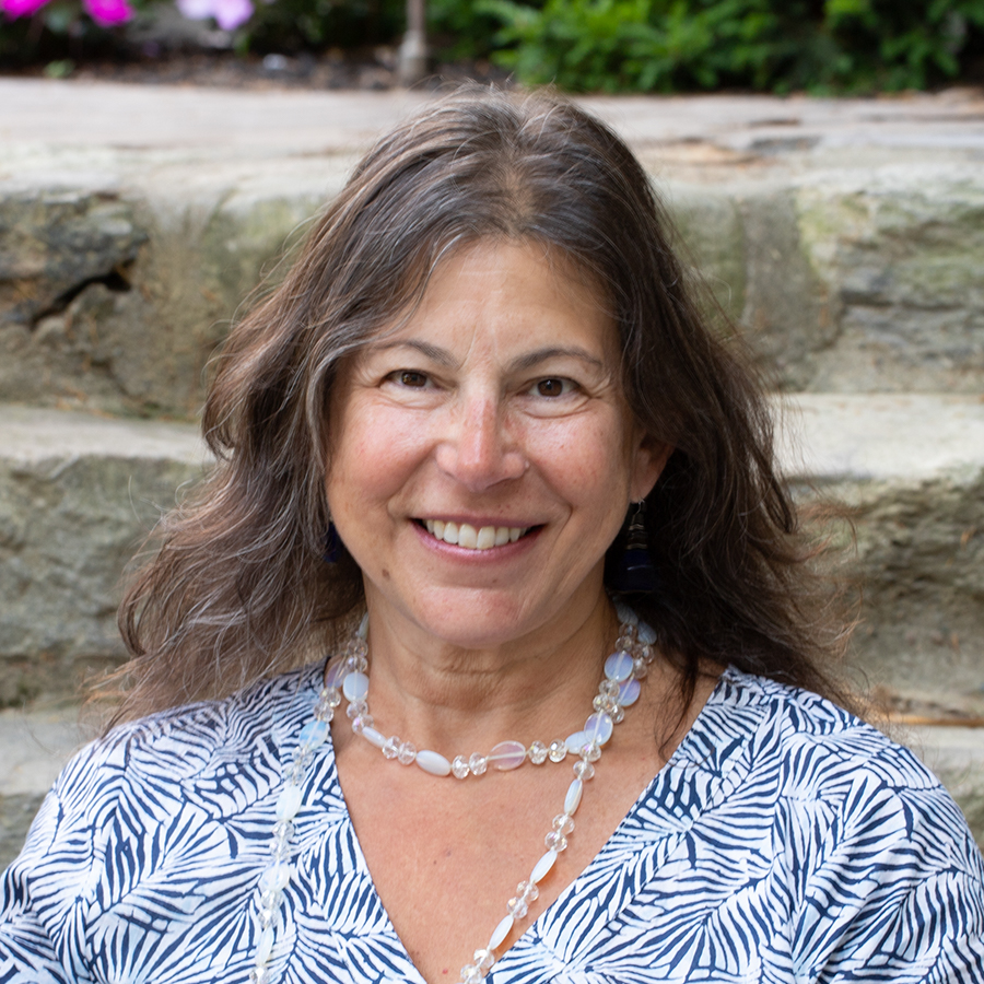 headshot of tracy hassett with stone background