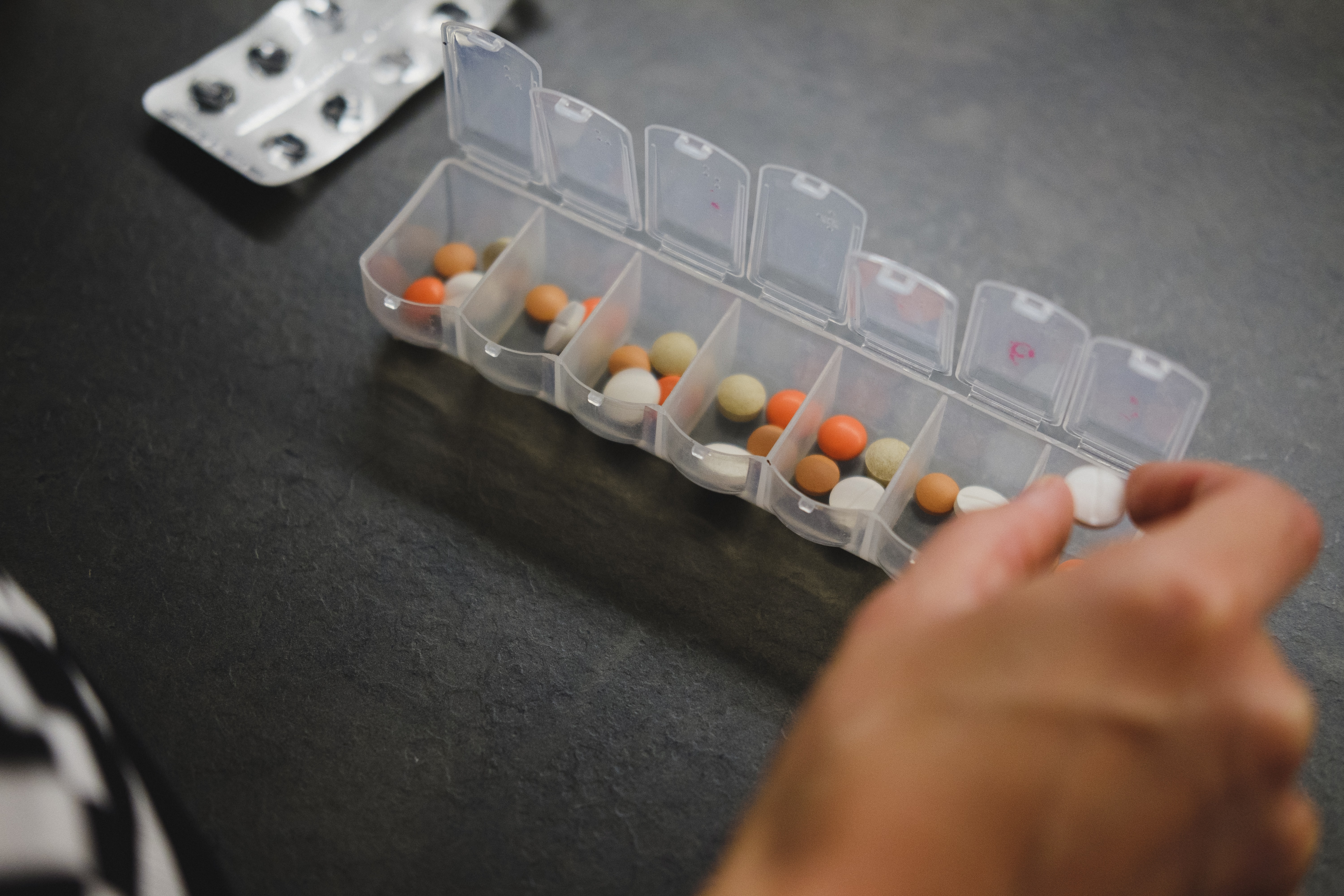 image of woman with her 7-day pill box.