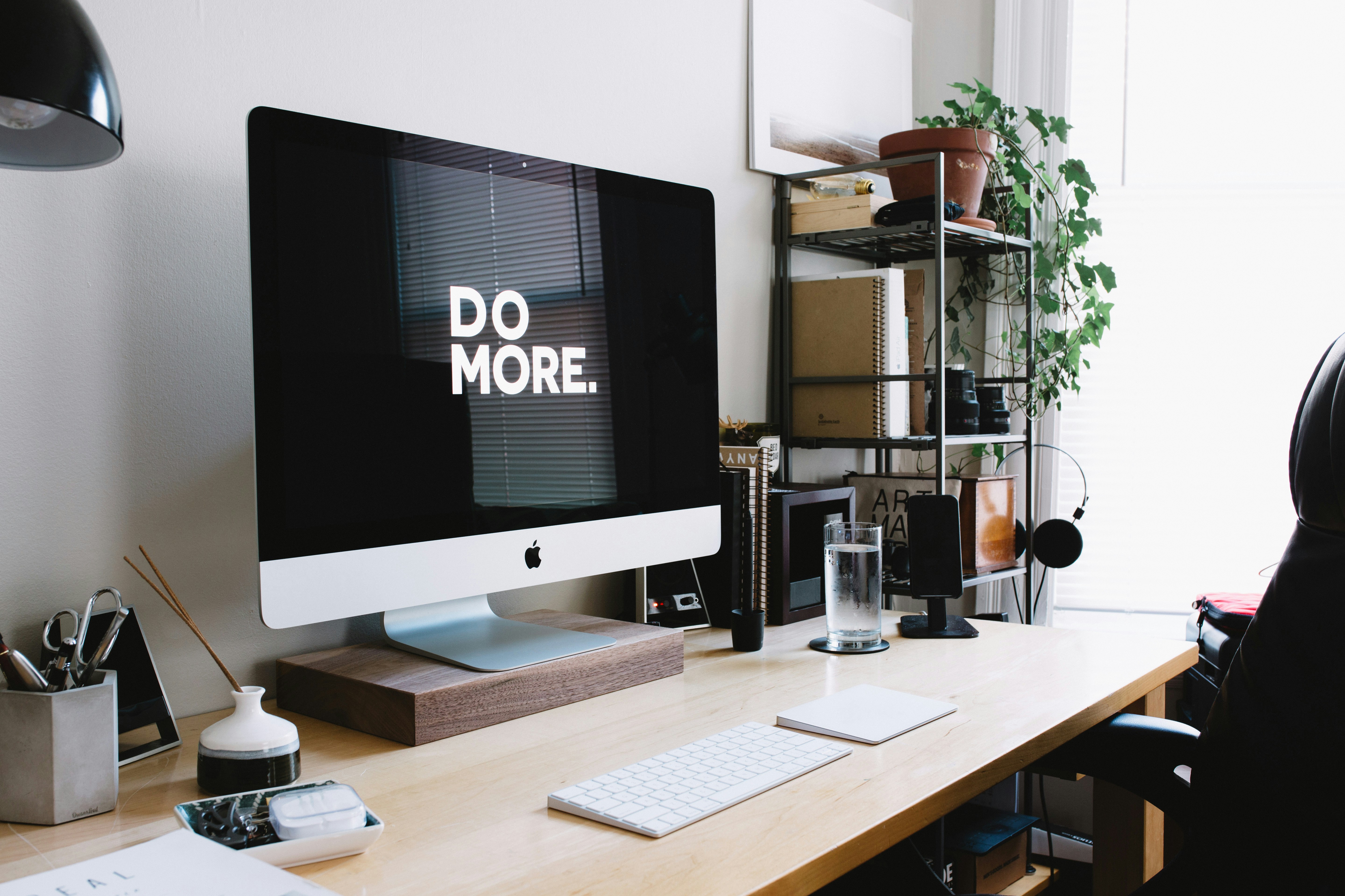 desk area with laptop monitor that says Do More